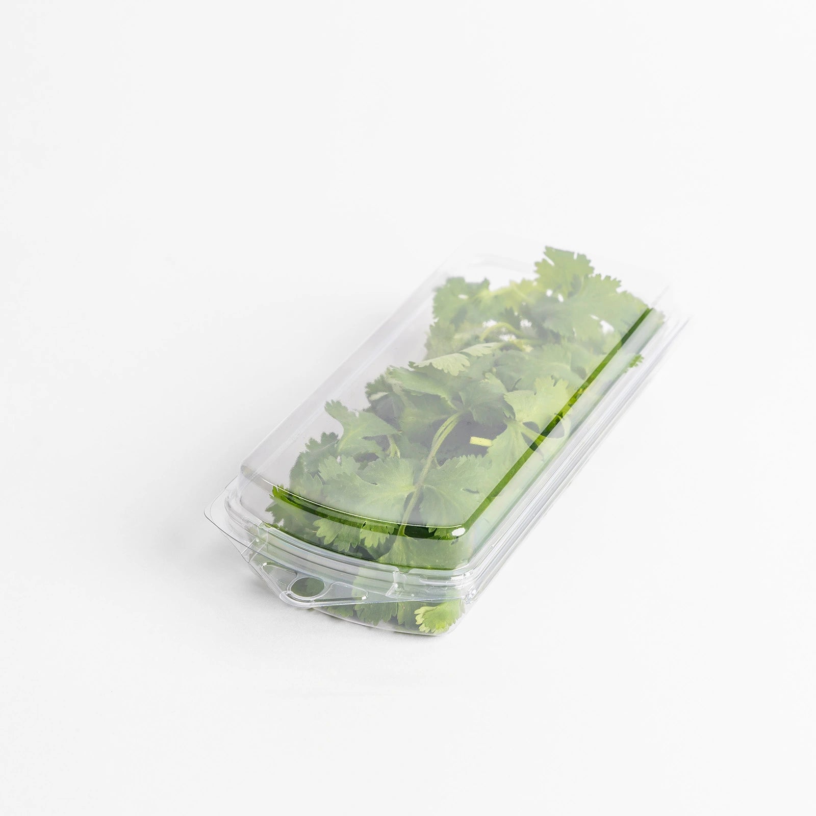 Photo · plastic-wrapped herbs on a supermarket shelf